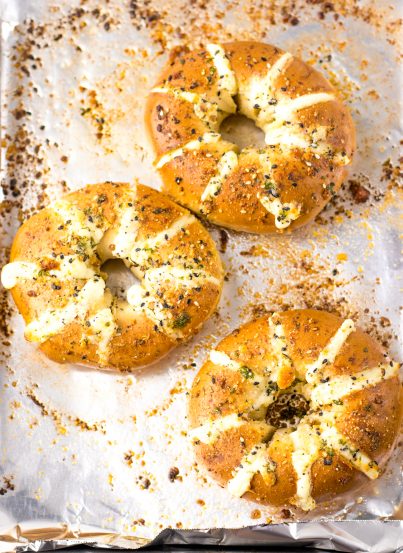 These Tik Tok Stuffed Bagels are going viral and there is a good reason! Bagels are sliced and stuffed with a sweetened cream cheese. They are brushed with a garlic butter and sprinkled with parmesan cheese before getting baked in the oven.  These totally take bagels to a whole new level.  This includes the directions for the air fryer, as well.