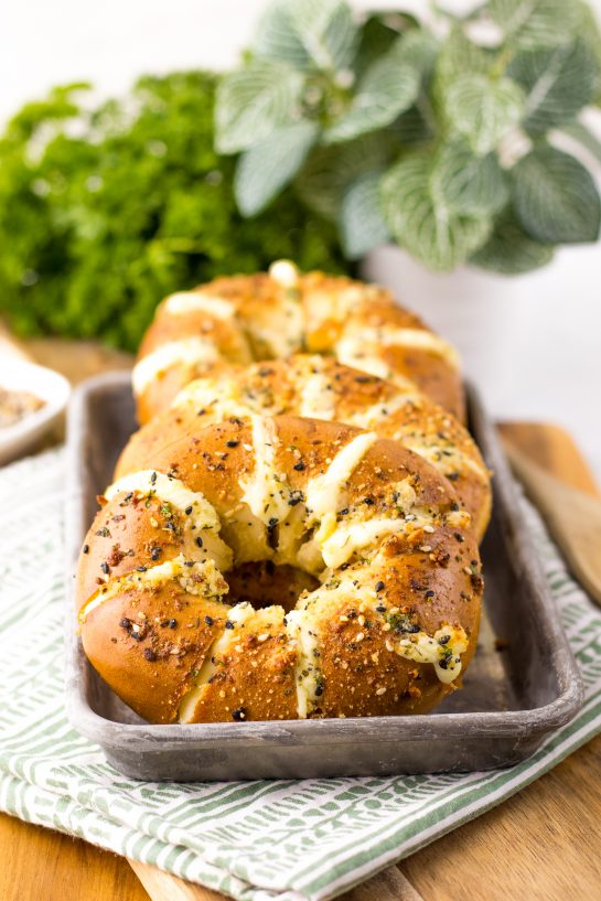 These Tik Tok Stuffed Bagels are going viral and there is a good reason! Bagels are sliced and stuffed with a sweetened cream cheese. They are brushed with a garlic butter and sprinkled with parmesan cheese before getting baked to perfection in the oven.