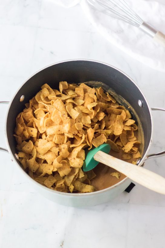 Mixing the Fritos with the other ingredients to make the Frito Candy recipe for Christmas