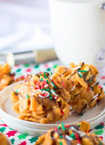 Frito Candy recipe is a creamy, gooey base of peanut butter candy gets tossed with salty Fritos for a fabulous treat for Christmas.  You will drizzle them with chocolate and top them with sprinkles and they are perfect for a holiday dessert tray or gifting.