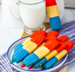 This recipe for Bomb Pop Cookies is not only so tasty but so cute for the 4th of July! These are the perfect dessert to bring for those red, white and blue holidays. Bursting with Sugar cookie flavors with hints of cherry flavoring in the red and blueberry flavoring in the blue, using Jello! These were so fun to make and were a huge hit for everybody involved!