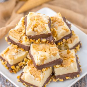 No-Bake Drumstick Ice Cream Fudge recipe inspired by the flavors of classic Drumstick ice cream cones. This is amazing, tasting just like the cones you ate as a child. Creamy fudge with crushed sugar cones on top, then dipped into a yummy chocolate and salted peanuts. Such a great, tasty and easy fudge!