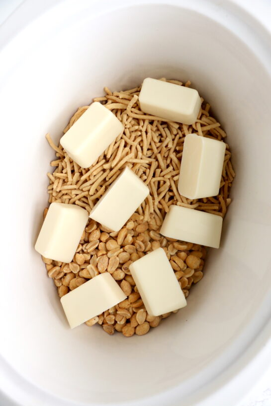 Melting the butter for this fun, festive, and easy White Chocolate Halloween Crock Pot Candy Recipe