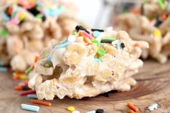 Close-up photo of the easy White Chocolate Halloween Crock Pot Candy made with crunchy chow mein noodles, creamy white chocolate bark, and colorful Halloween sprinkles.