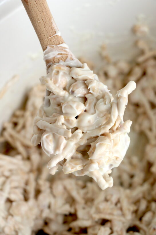 Close-up photo in the crock pot of this fun, festive, and easy White Chocolate Halloween Crock Pot Candy Recipe