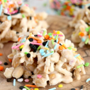 Get ready for Halloween with this fun, festive, and easy White Chocolate Halloween Crock Pot Candy made with crunchy chow mein noodles, creamy white chocolate bark, and colorful Halloween sprinkles. These no-bake Halloween treats are the perfect last-minute party snack or spooky holiday dessert made right in the slow cooker that kids and adults will love.