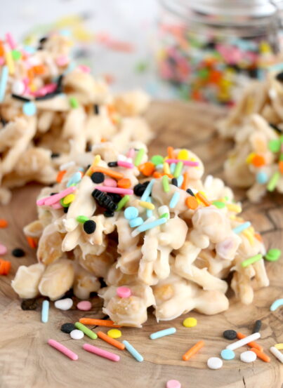 Get ready for Halloween with this fun, festive, and easy White Chocolate Halloween Crock Pot Candy made with crunchy chow mein noodles, creamy white chocolate bark, and colorful Halloween sprinkles. These no-bake Halloween treats are the perfect last-minute party snack or spooky holiday dessert made right in the slow cooker that kids and adults will love.