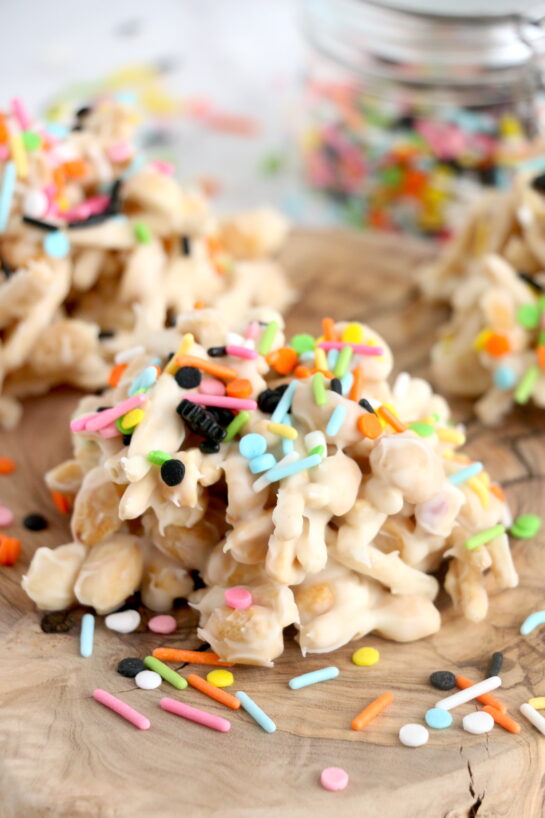 Get ready for Halloween with this fun, festive, and easy White Chocolate Halloween Crock Pot Candy made with crunchy chow mein noodles, creamy white chocolate bark, and colorful Halloween sprinkles. These no-bake Halloween treats are the perfect last-minute party snack or spooky holiday dessert made right in the slow cooker that kids and adults will love.