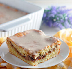 This Honey Bun Cake recipe made with yellow cake mix, sour cream, and chopped pecans is a Southern-inspired dessert that tastes just like a warm bakery honey bun! Perfectly moist, swirled with brown sugar and cinnamon, this easy doctored cake mix recipe comes together in minutes — no fancy baking skills required.