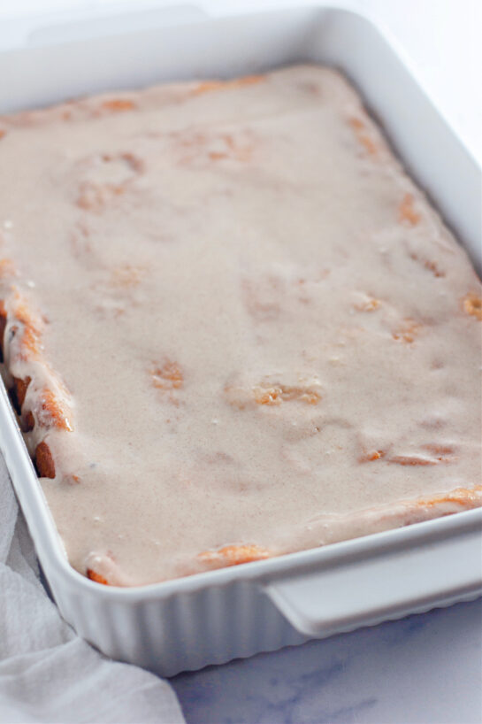 Photo of pouring the sweet glaze onto Honey Bun Cake recipe