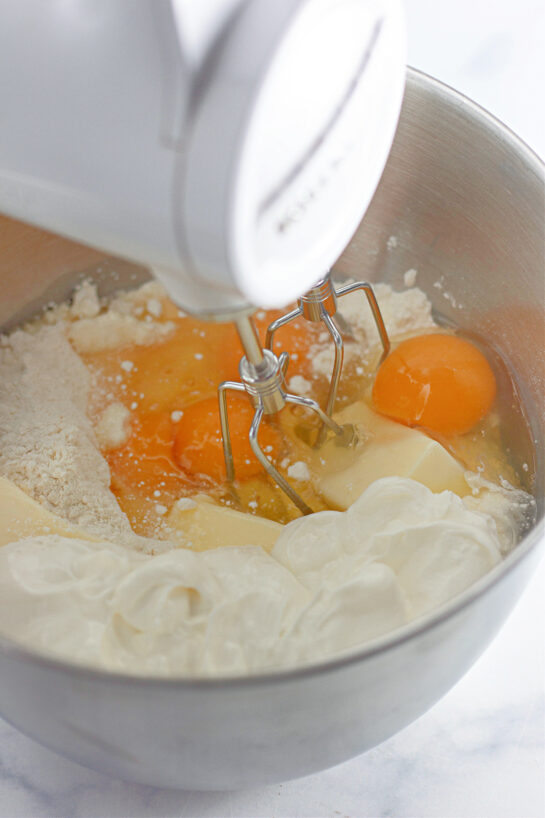 Mixing the ingredients needed to make the Honey Bun Cake recipe for the holidays