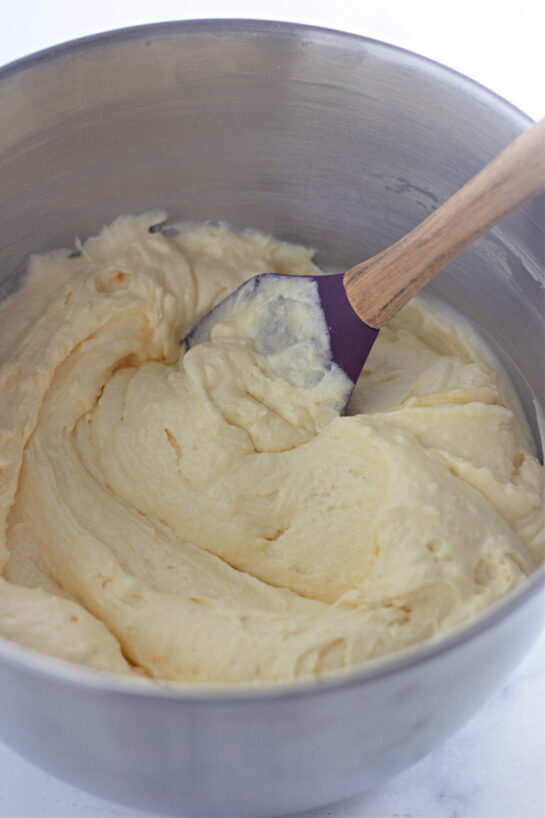 Mixing the frosting to make the Honey Bun Cake recipe for the holidays