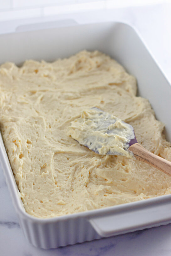 Spreading the cake batter into the pan to get ready to bake the Honey Bun Cake recipe