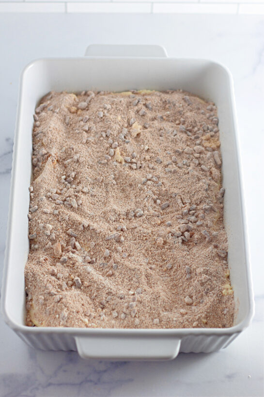 Adding the pecan topping to make the Honey Bun Cake recipe for the holidays