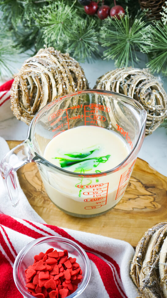 Mixing the food coloring and sweetened condensed milk together to make green