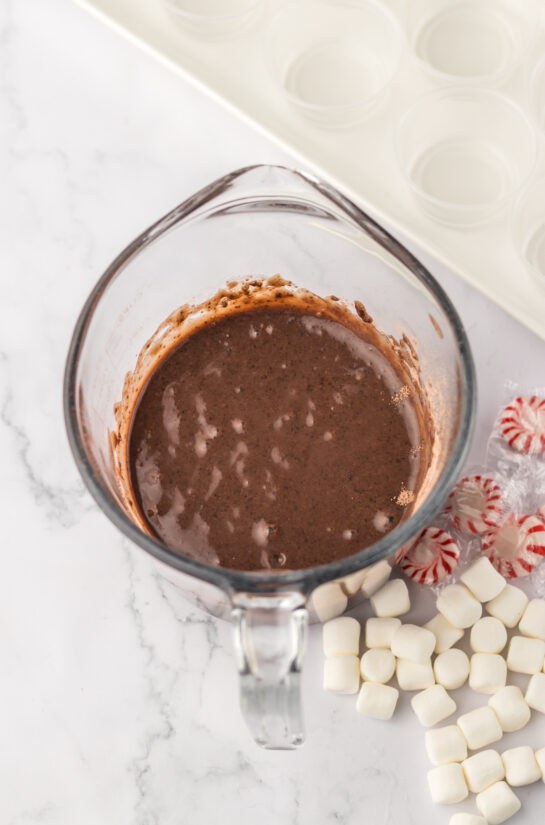 Bailey's Irish cream with the chocolate pudding mix ready to be added for the hot chocolate pudding shots recipe