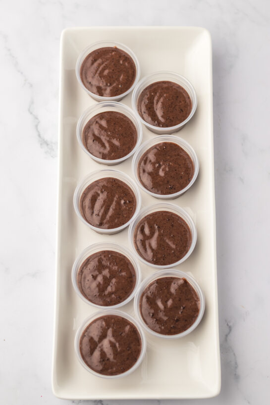 Pouring in the mixture of Bailey's Irish cream with the chocolate pudding mix for the hot chocolate pudding shots recipe