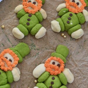 Lucky Leprechaun Cookies made with green and white sugar cookie dough, mini chocolate chip buttons, and fluffy orange frosting beards. These cute, chubby St. Patrick's Day leprechaun cookies are a fun, festive, and easy holiday dessert recipe perfect for parties, kids, and St. Patrick’s Day baking. 