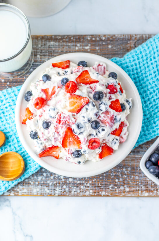 Overhead, zoomed out photo of the berry cheesecake salad for the 4th of July summer picnic.