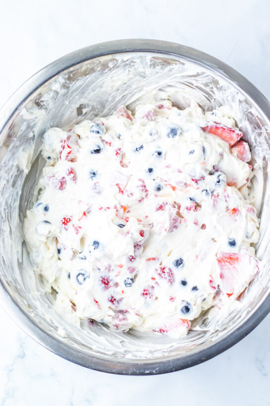Mixing the ingredients needed to make the Berry Cheesecake Salad recipe